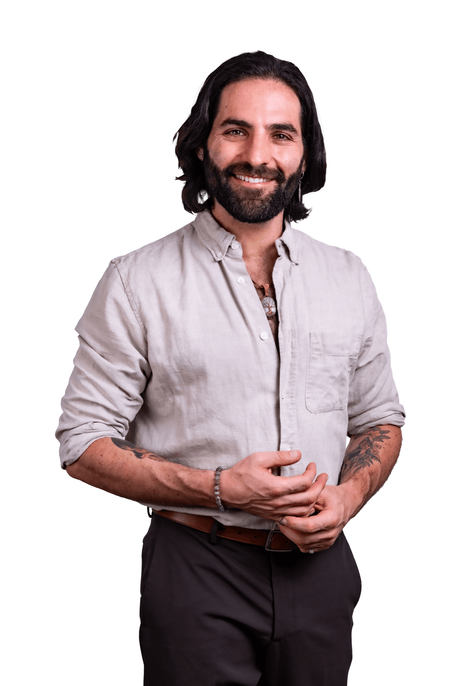 Joseph Buchoff in a stone linen shirt, hands loosely clasped, smiling warmly